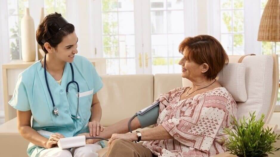 Healthcare professional monitoring resident blood pressure
